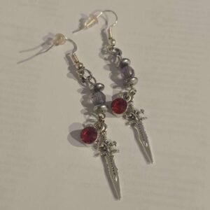Cute silver sword earrings with a red charm and black bread